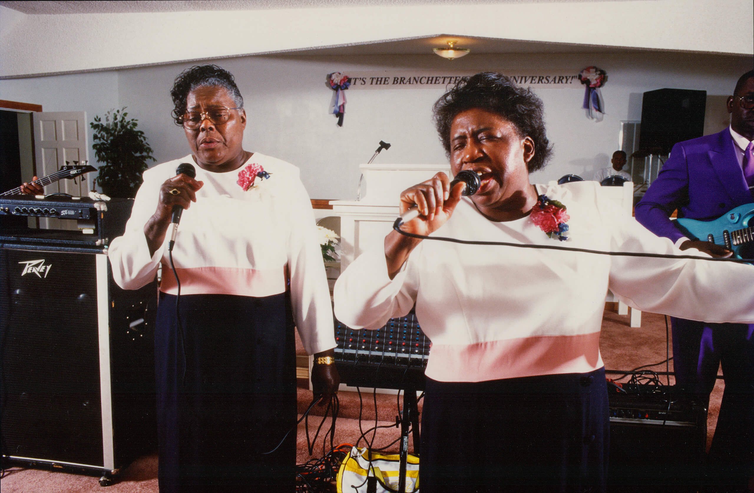 Ethel Mae Elliot, left, and Lena Mae Perry, right, perform at The Branchettes 23rd Anniversary in 1996, Long Branch Disciples of Christ, New Grove, North Carolina. Photo by Roland L. Freeman, from the documentary film STAY PRAYED UP.