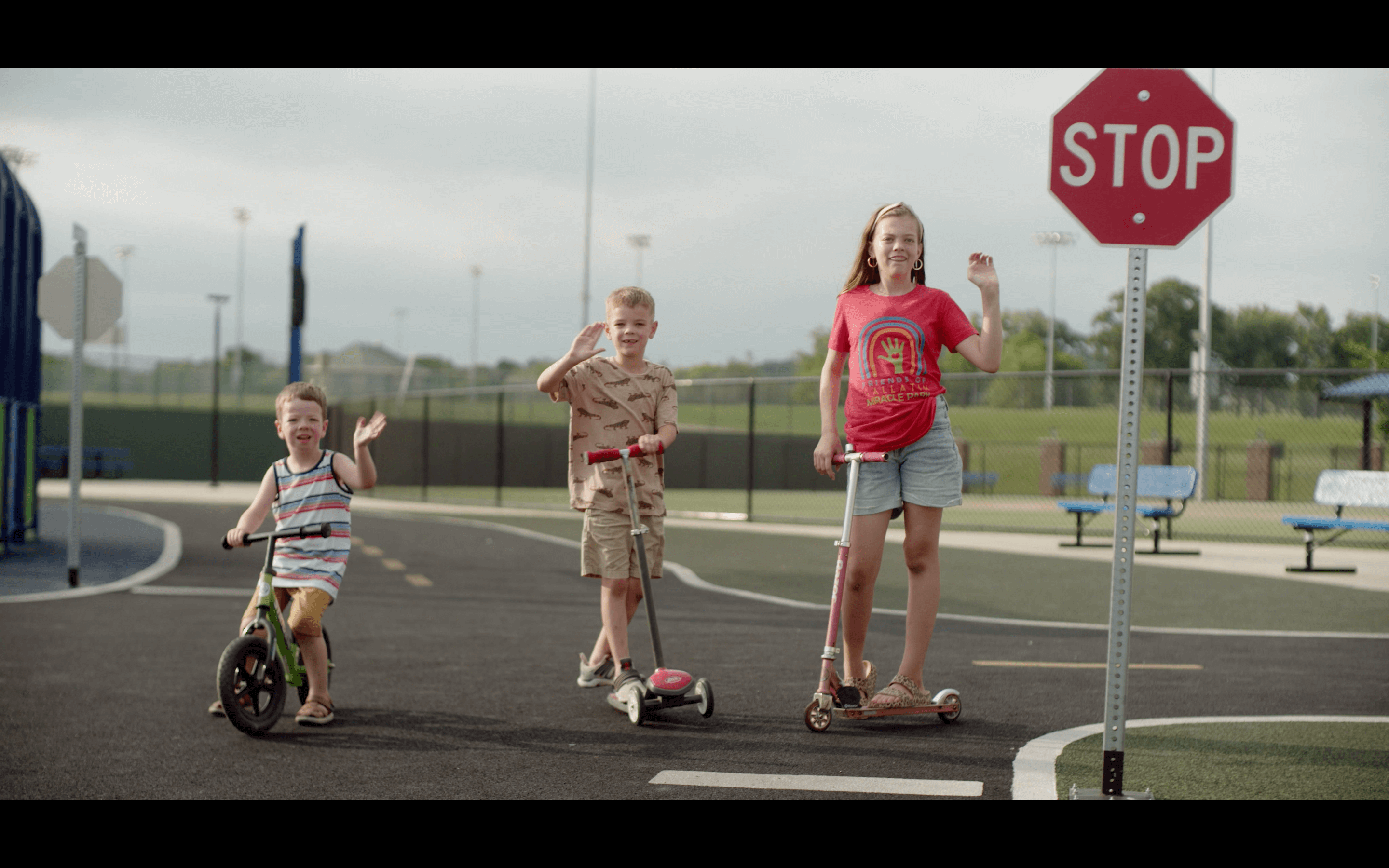 Three kids waving