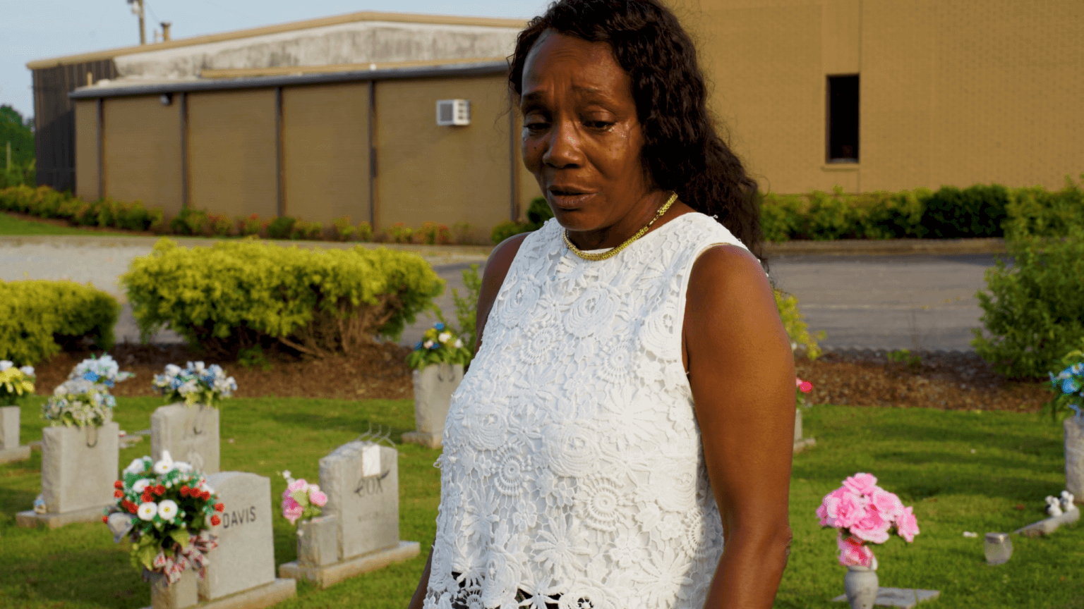 Brenda Hampton crying at a grave site.